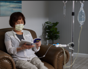 Home dialysis patient reading book while receiving treatment