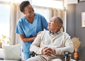 Support worker and elderly client sharing a laugh