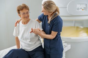 Home care support worker assisting patient recovering from medical procedure